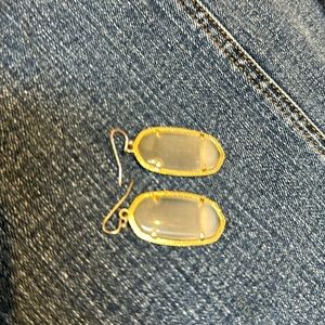 Kendra Scott gold and mother of pearl drop earrings.